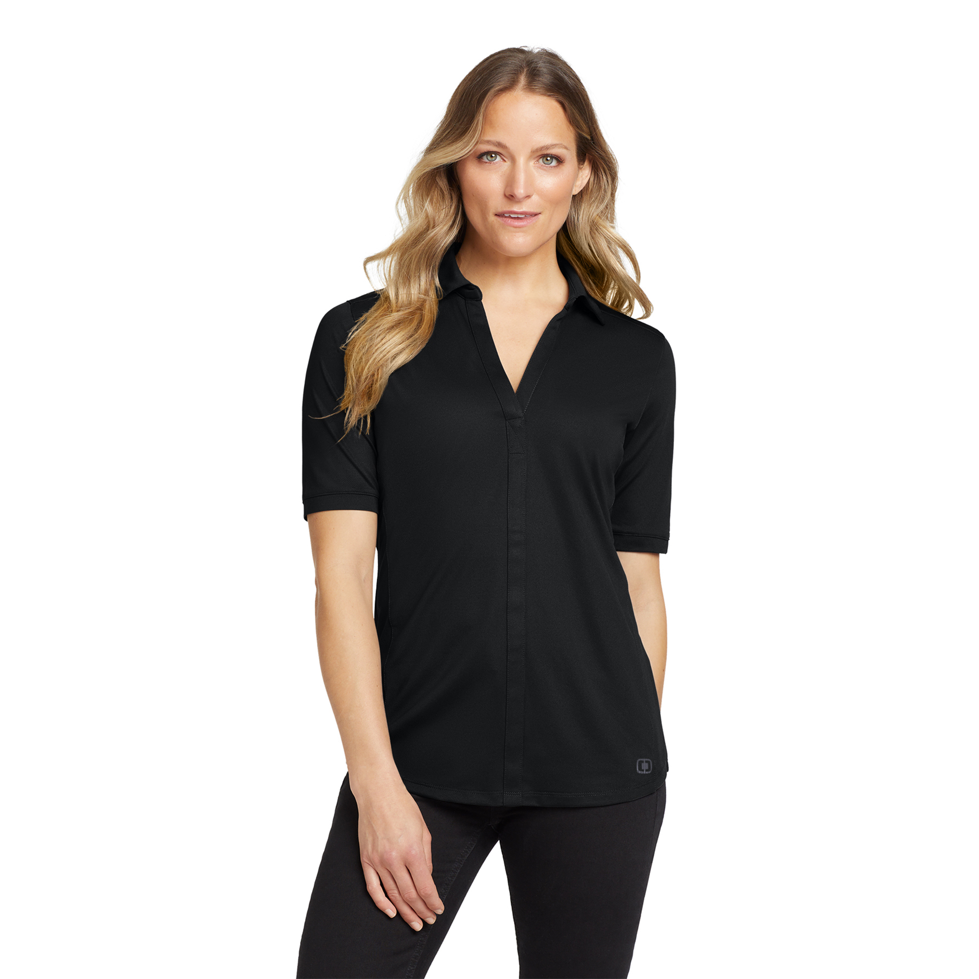 Portrait of a woman with long wavy blonde hair wearing a black short-sleeve polo against a white background, facing the camera.