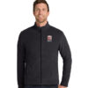 Man wearing a dark zip-up jacket with a small 'City of Benicia' emblem on the chest.
